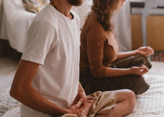 Person practicing deep breathing techniques in a sunlit room